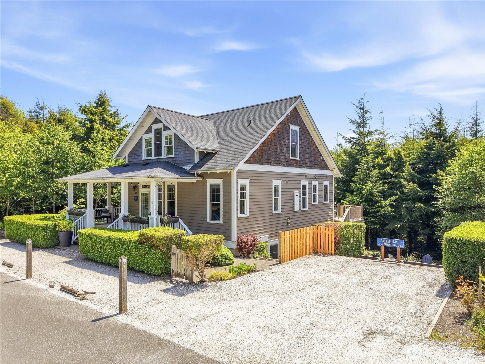 269 Compass Street Pacific Beach, WA 98571 - Photo 2 of 38 a front view of a house with a yard and potted plants