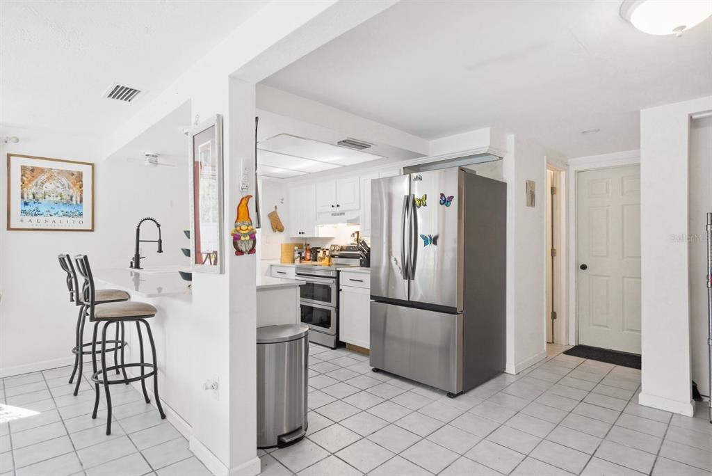 4276 Rudder Way New Port Richey, FL 34652 - Photo 8 of 29 a kitchen with stainless steel appliances a refrigerator and a stove top oven
