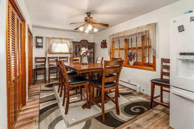a view of a dining room with furniture and a chandelier