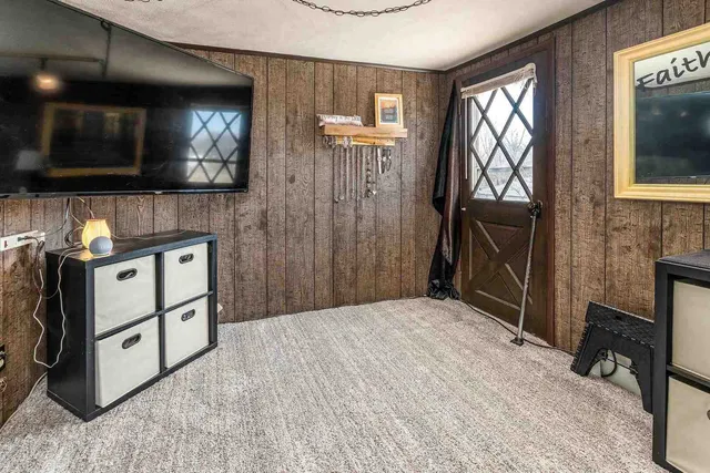 a bedroom with a bed and a television