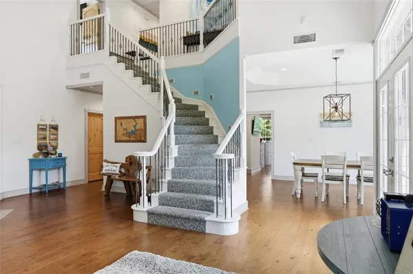 a view of entryway and dining room with wooden floor