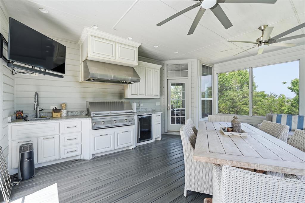 606 Lake Point Loop Pottsboro, TX 75076 - Photo 22 of 40 a kitchen with stainless steel appliances granite countertop a stove and a wooden floors