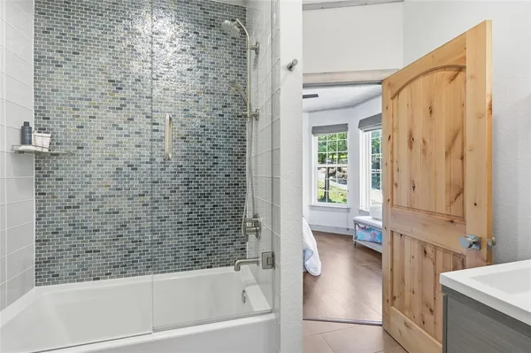 a bathroom with a bathtub and a shower