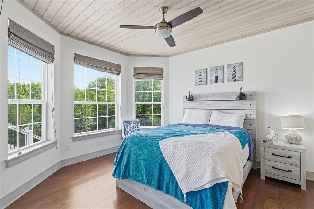 606 Lake Point Loop Pottsboro, TX 75076 - Photo 29 of 40 a bedroom with a large bed and a large window