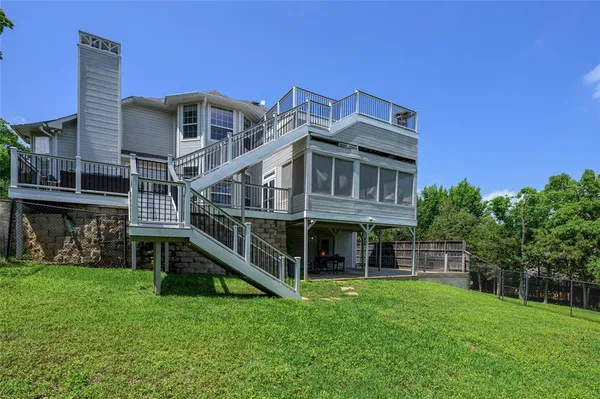 a view of a house with a backyard porch and sitting area