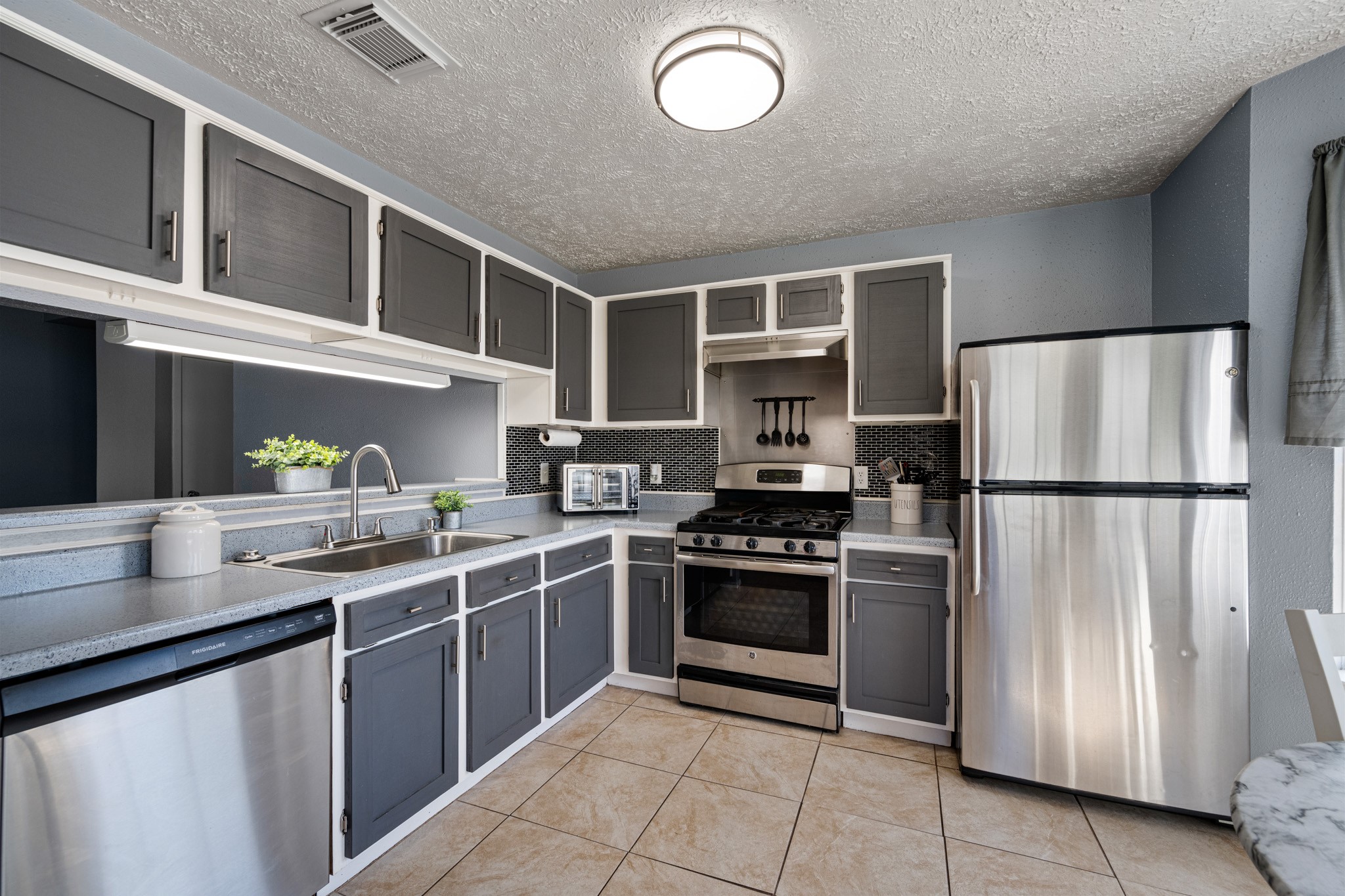1804 Spruce Drive Rosenberg, TX 77471 - Photo 9 of 29 a kitchen with stainless steel appliances granite countertop a sink stove and refrigerator