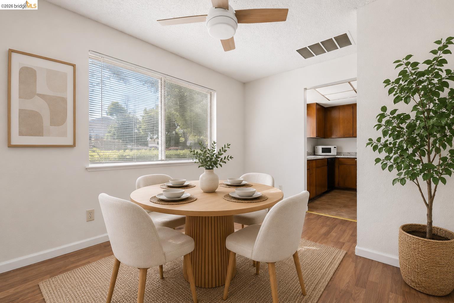 1151 Chadwick Circle Bay Point, CA 94565 - Photo 9 of 23 Dining area featuring wood-finish flooring, a contemporary ceiling fan, and a large window with horizontal blinds