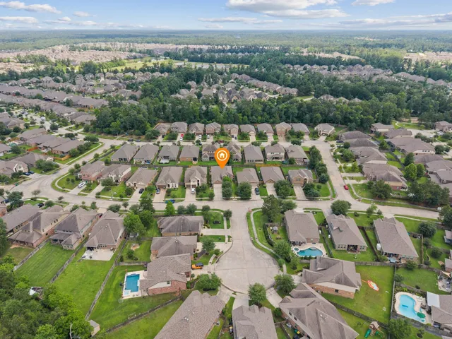 an aerial view of residential houses with outdoor space