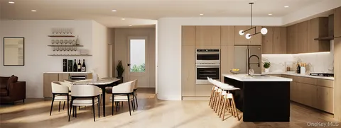 a kitchen with kitchen island a dining table chairs sink and microwave