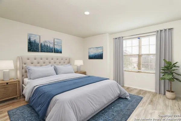a bedroom with bed and wooden floor