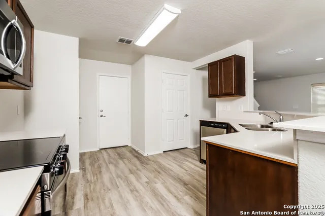 a kitchen with a sink appliances and cabinets