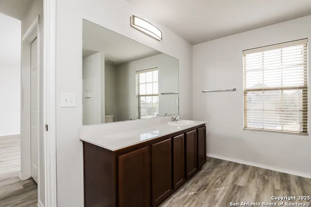 a kitchen with a sink window and cabinets