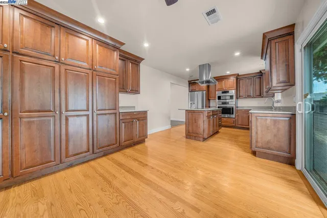 a kitchen with stainless steel appliances granite countertop a refrigerator and a sink