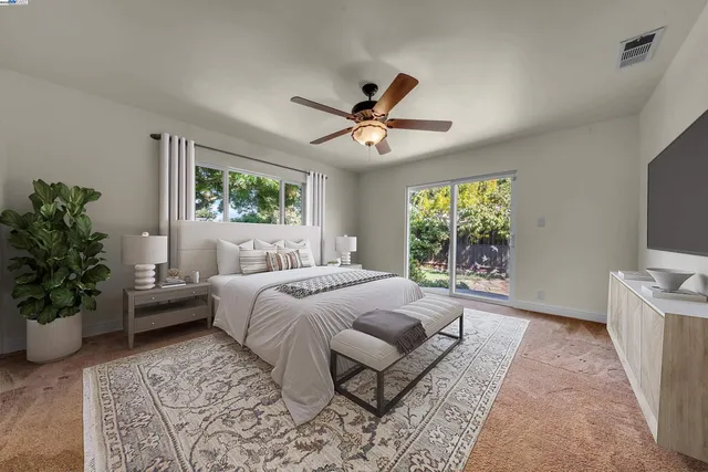 a bedroom with a large bed and a window