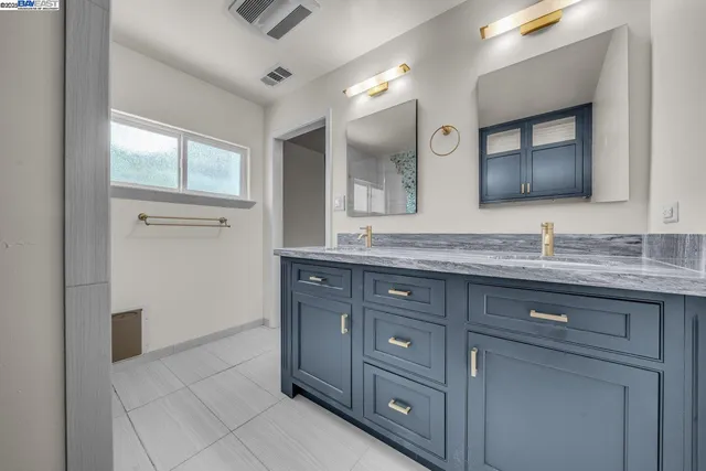 a bathroom with a granite countertop sink mirror and