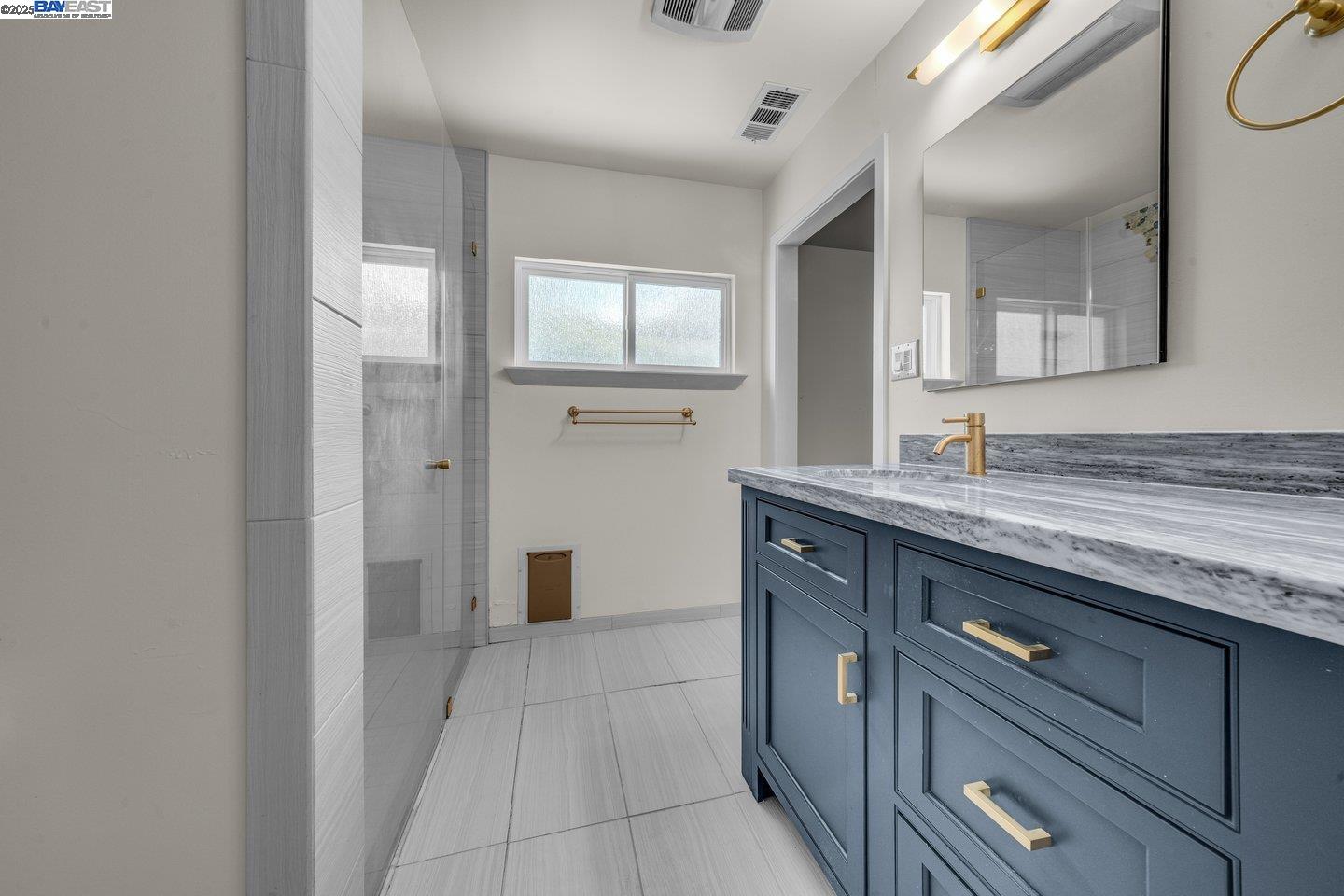 1876 Lynwood Drive Concord, CA 94519 - Photo 20 of 39 a spacious bathroom with a granite countertop sink and a mirror