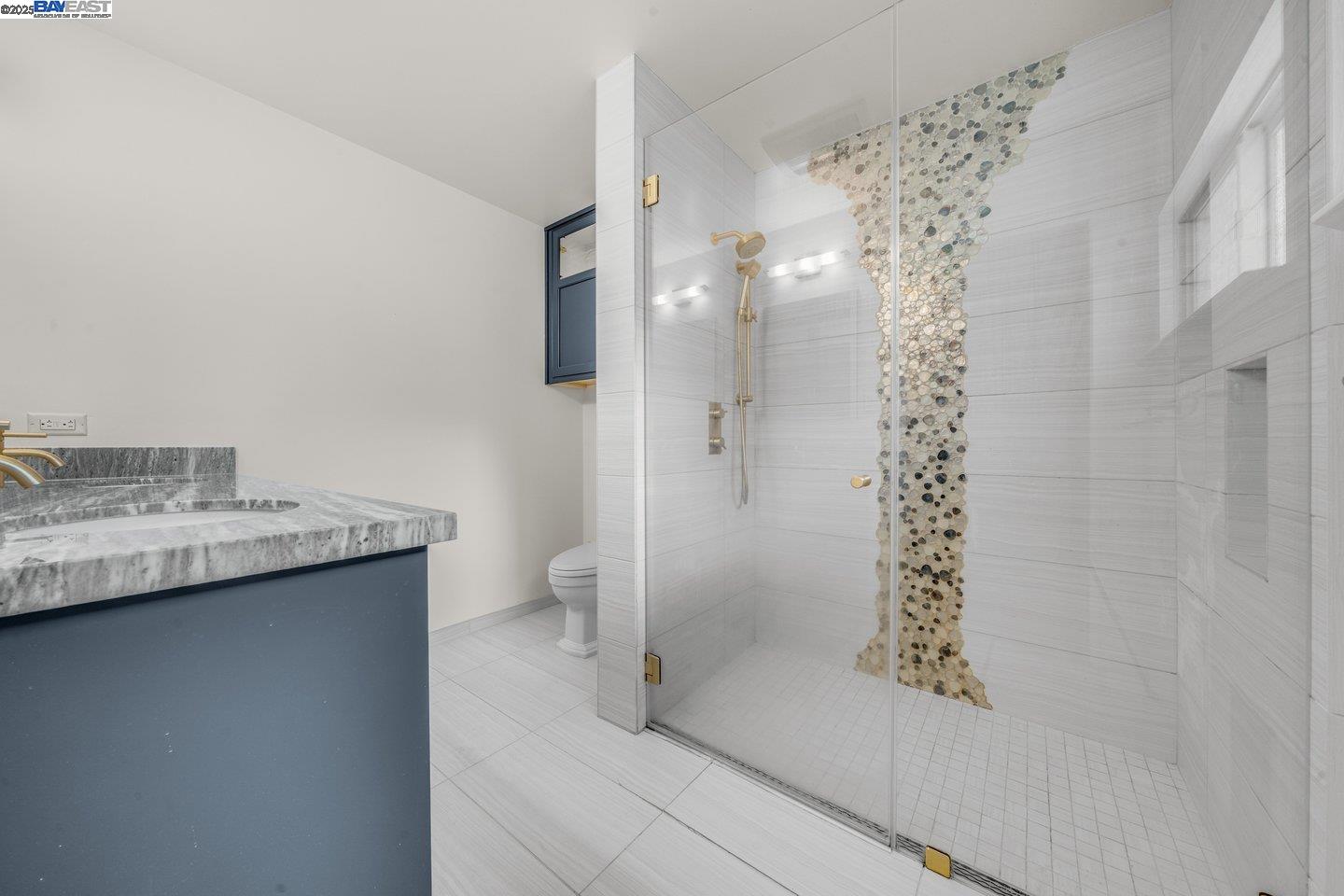 1876 Lynwood Drive Concord, CA 94519 - Photo 22 of 39 a bathroom with a granite countertop sink a toilet and shower