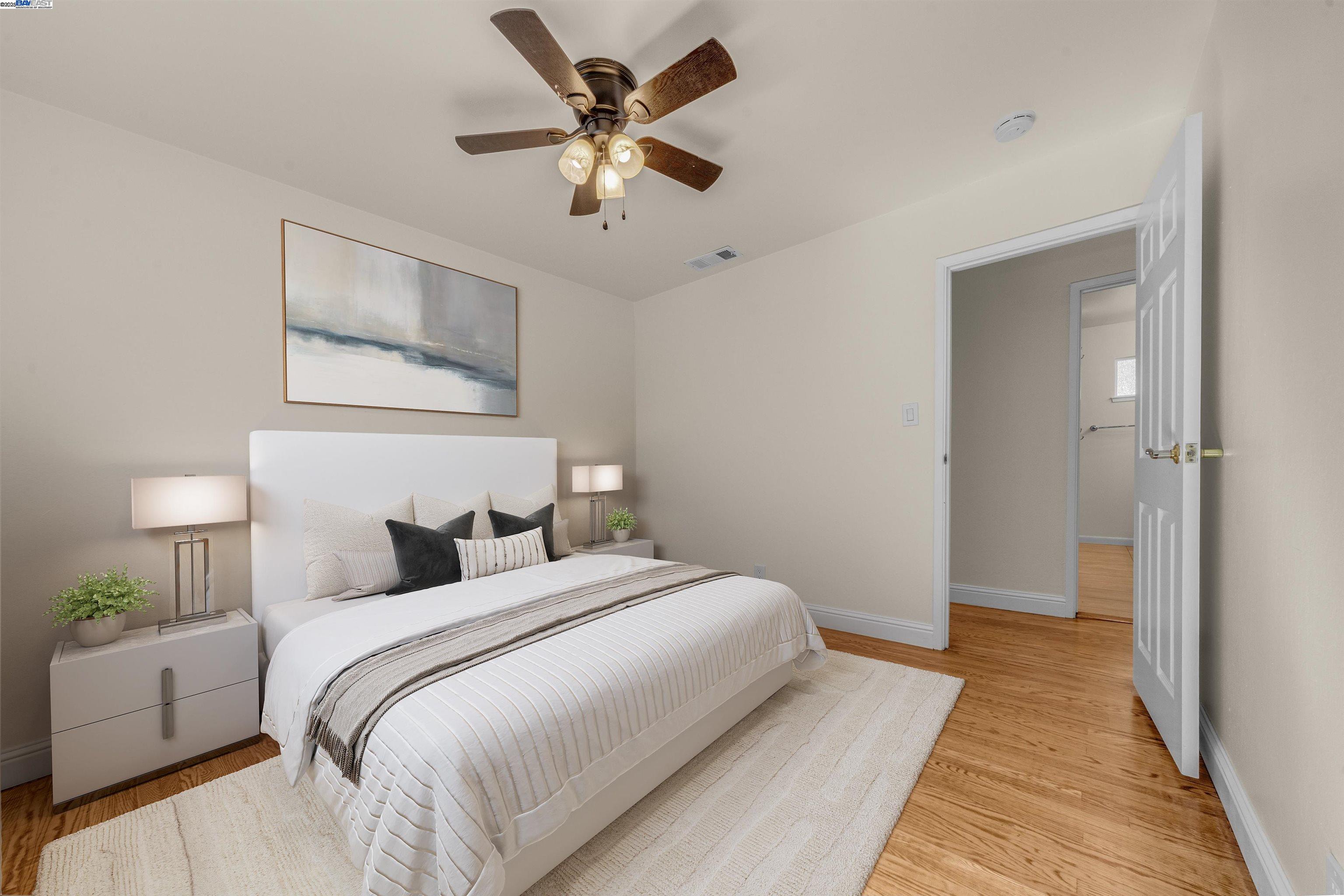 1876 Lynwood Drive Concord, CA 94519 - Photo 27 of 39 a bedroom with a large bed and a chandelier