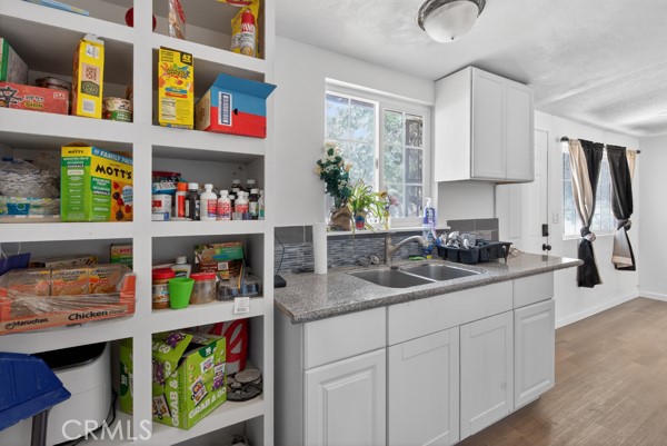 13391 Mesquite Road Whitewater, CA 92282 - Photo 10 of 27 a kitchen that has a lot of cabinets and wooden floor