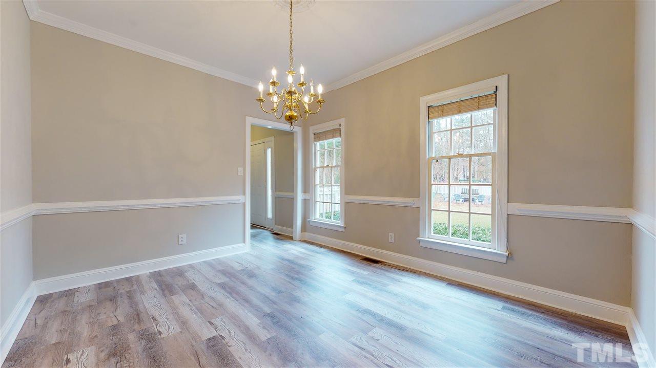 1301 October Road Raleigh, NC 27614 - Photo 14 of 30 an empty room with wooden floor and windows