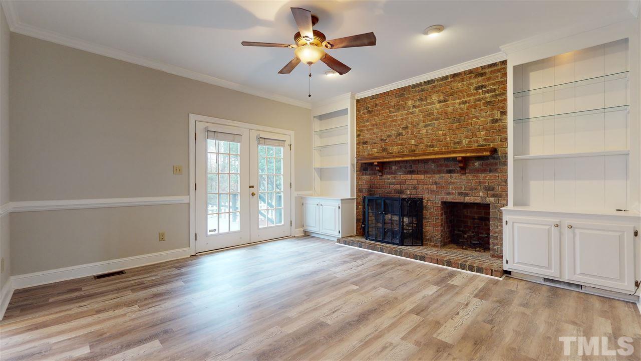 1301 October Road Raleigh, NC 27614 - Photo 8 of 30 a view of an empty room with a fireplace and a window