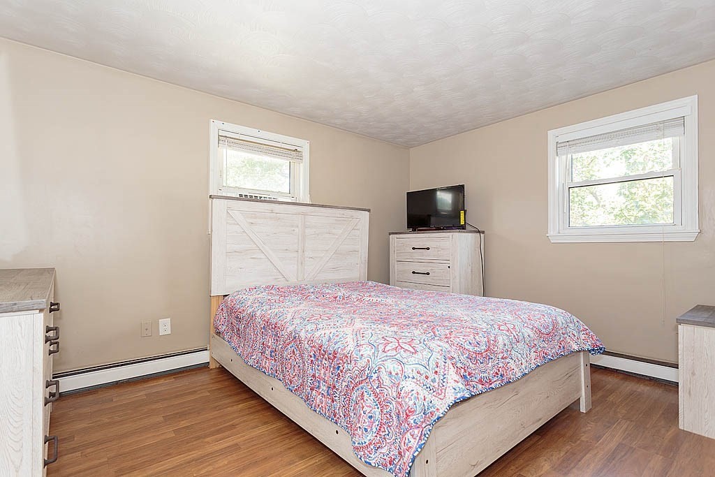 38 McDevitt Road Randolph, MA 02368 - Photo 13 of 22 a bedroom with a bed and wooden floor