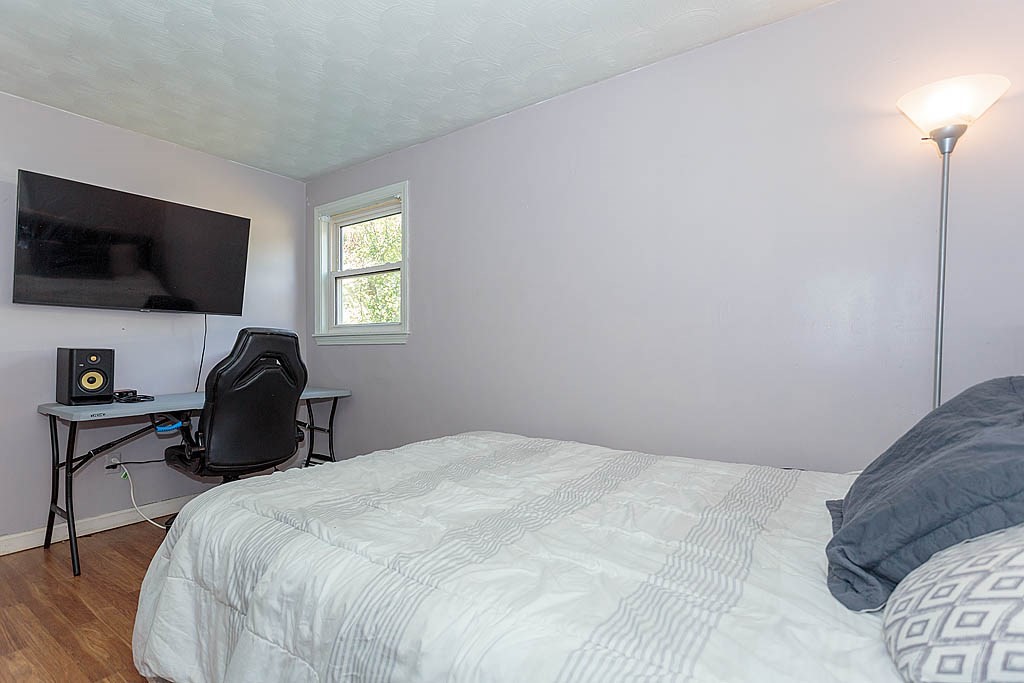 38 McDevitt Road Randolph, MA 02368 - Photo 14 of 22 a bedroom with a bed and a flat screen tv
