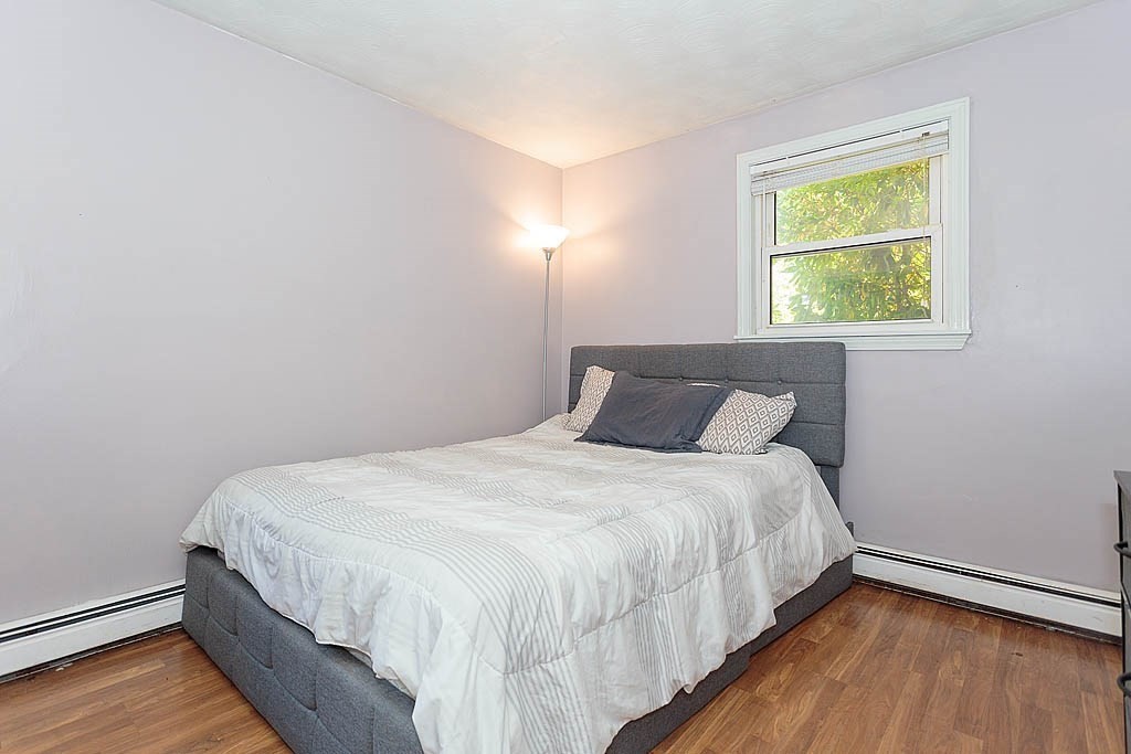 38 McDevitt Road Randolph, MA 02368 - Photo 15 of 22 a large bed sitting in a bedroom next to a window