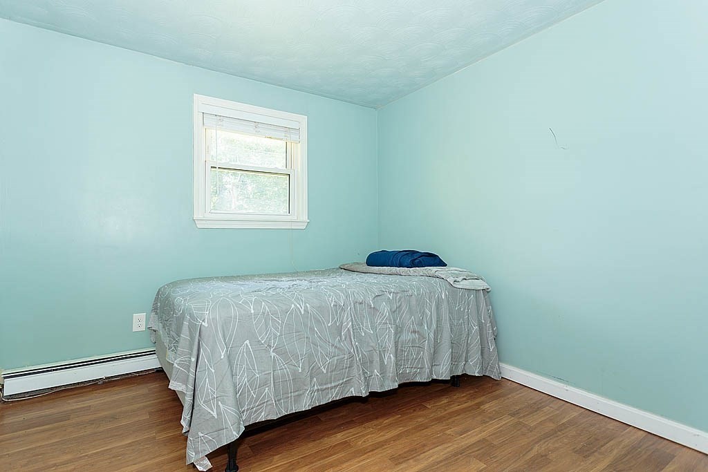 38 McDevitt Road Randolph, MA 02368 - Photo 16 of 22 a bedroom with a bed and wooden floor