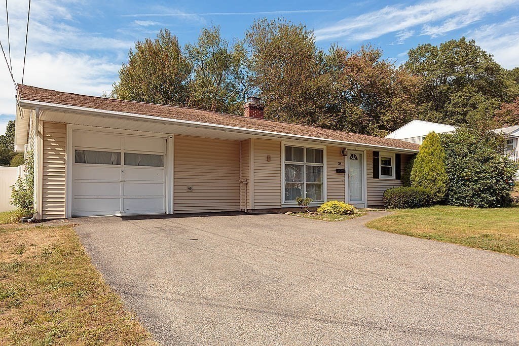 38 McDevitt Road Randolph, MA 02368 - Photo 2 of 22 a front view of a house with a yard and garage