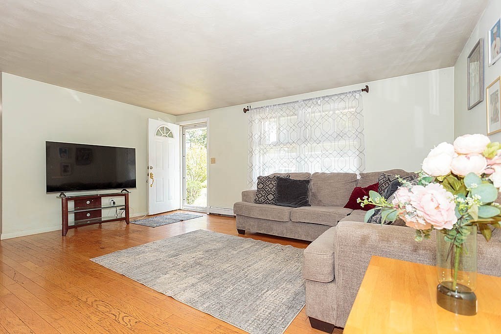 38 McDevitt Road Randolph, MA 02368 - Photo 8 of 22 a living room with furniture and a flat screen tv