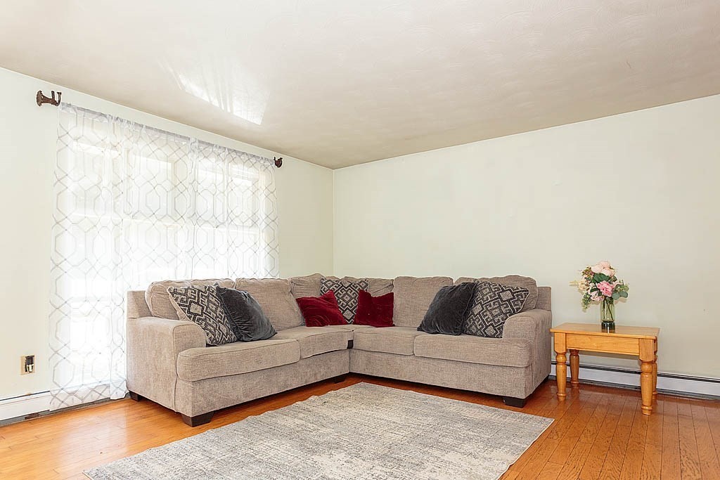 38 McDevitt Road Randolph, MA 02368 - Photo 9 of 22 a living room with furniture and a couch with wooden floor