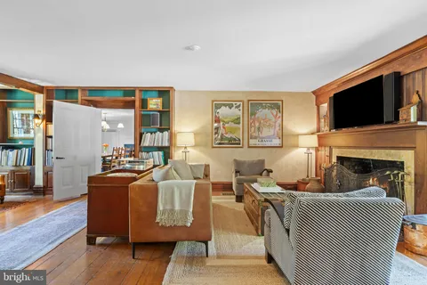 a living room with furniture fireplace and flat screen tv
