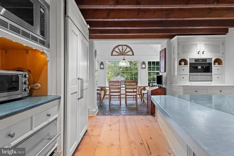 a kitchen with stainless steel appliances granite countertop a sink and wooden cabinets
