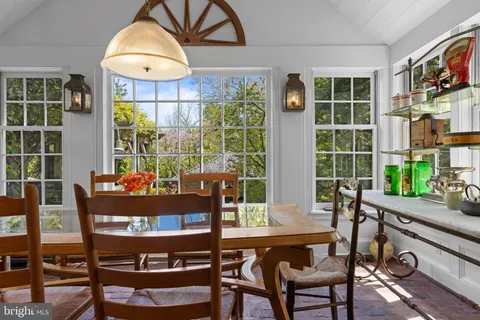 a view of a dining room with furniture a rug and wooden floor