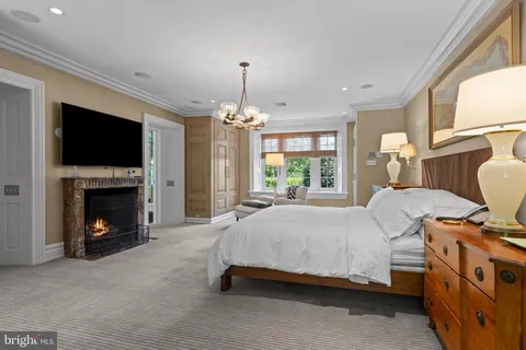 a spacious bedroom with a bed and a fireplace
