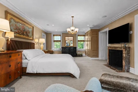 a spacious bedroom with a bed and a flat screen tv