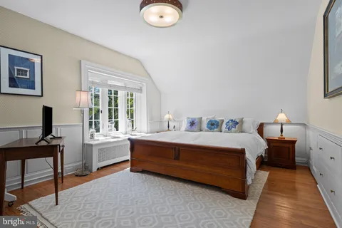 a spacious bedroom with a bed and a desk