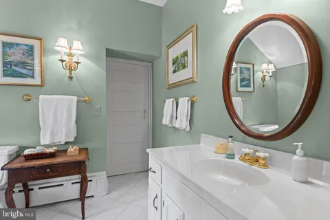 a bathroom with a sink a mirror and a toilet