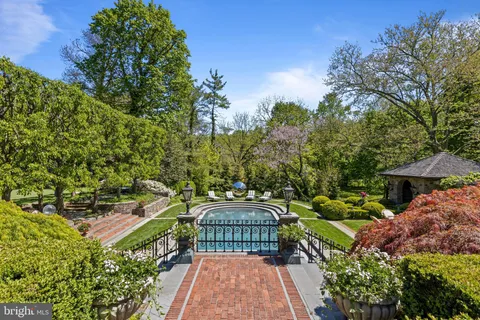 a view of a swimming pool with lounge chairs in patio