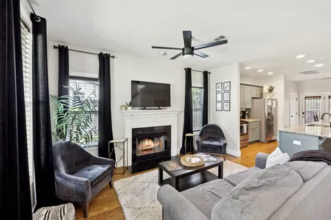 a living room with furniture and a fireplace