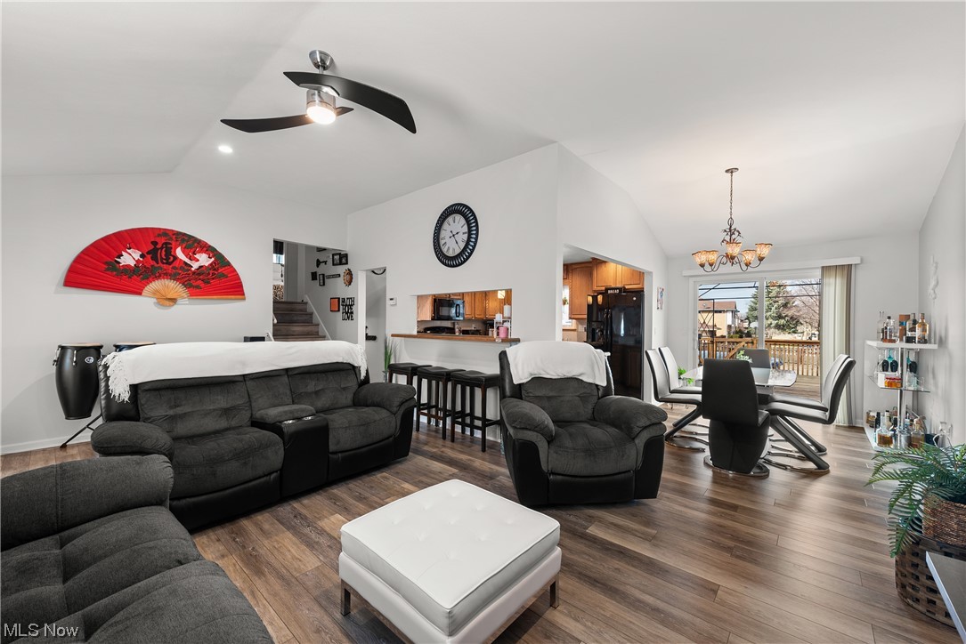 7094 Brandywine Road Parma Heights, OH 44130 - Photo 21 of 49 Living room featuring ceiling fan with notable chandelier, dark hardwood / wood-style floors, and vaulted ceiling