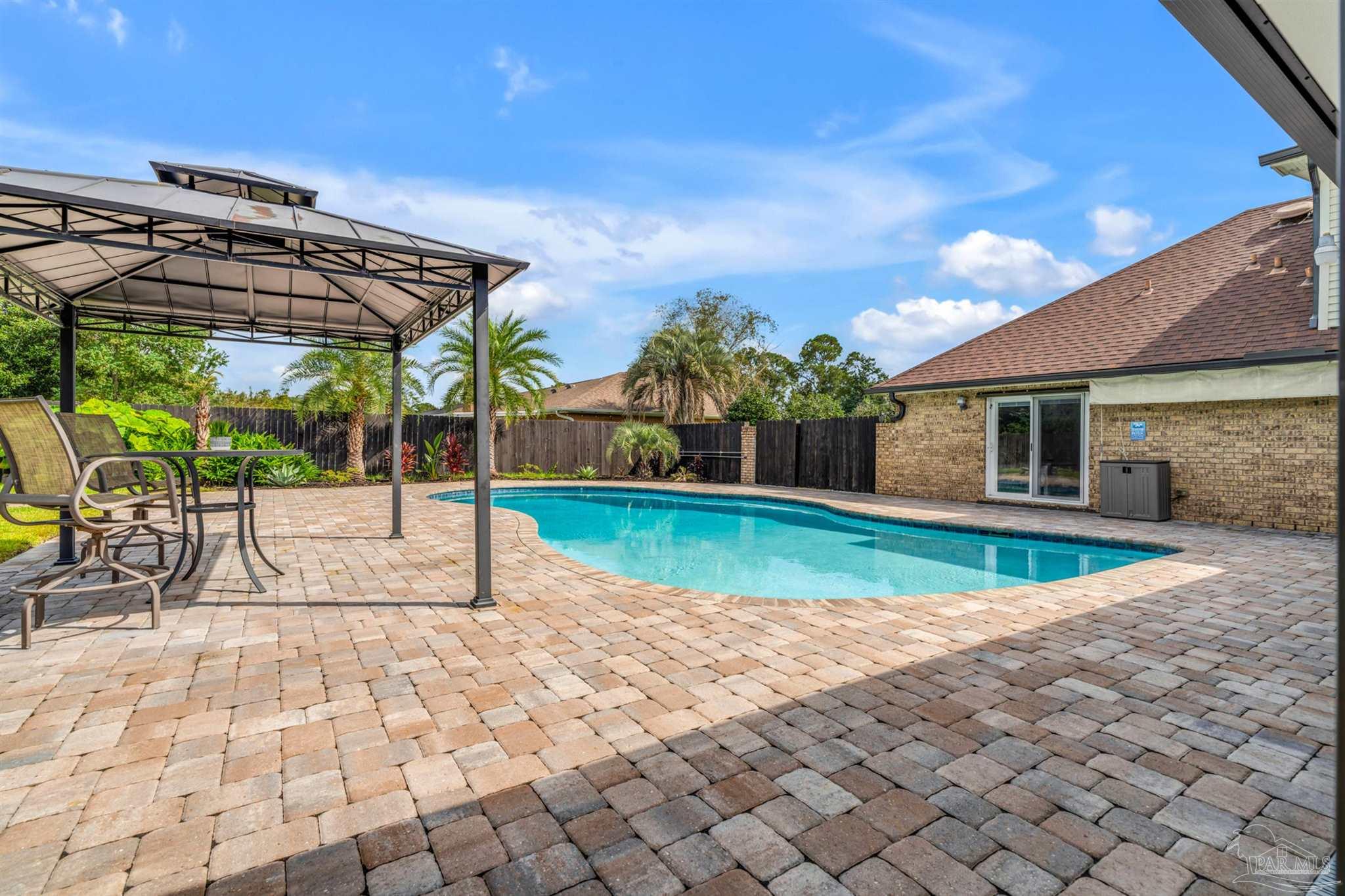 6912 Kitty Hawk Drive Pensacola, FL 32506 - Photo 11 of 61 a view of a house with backyard porch and sitting area