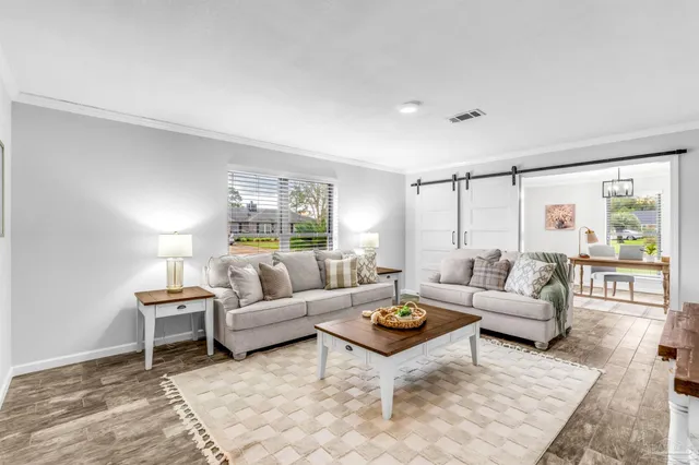 a living room with furniture and a flat screen tv
