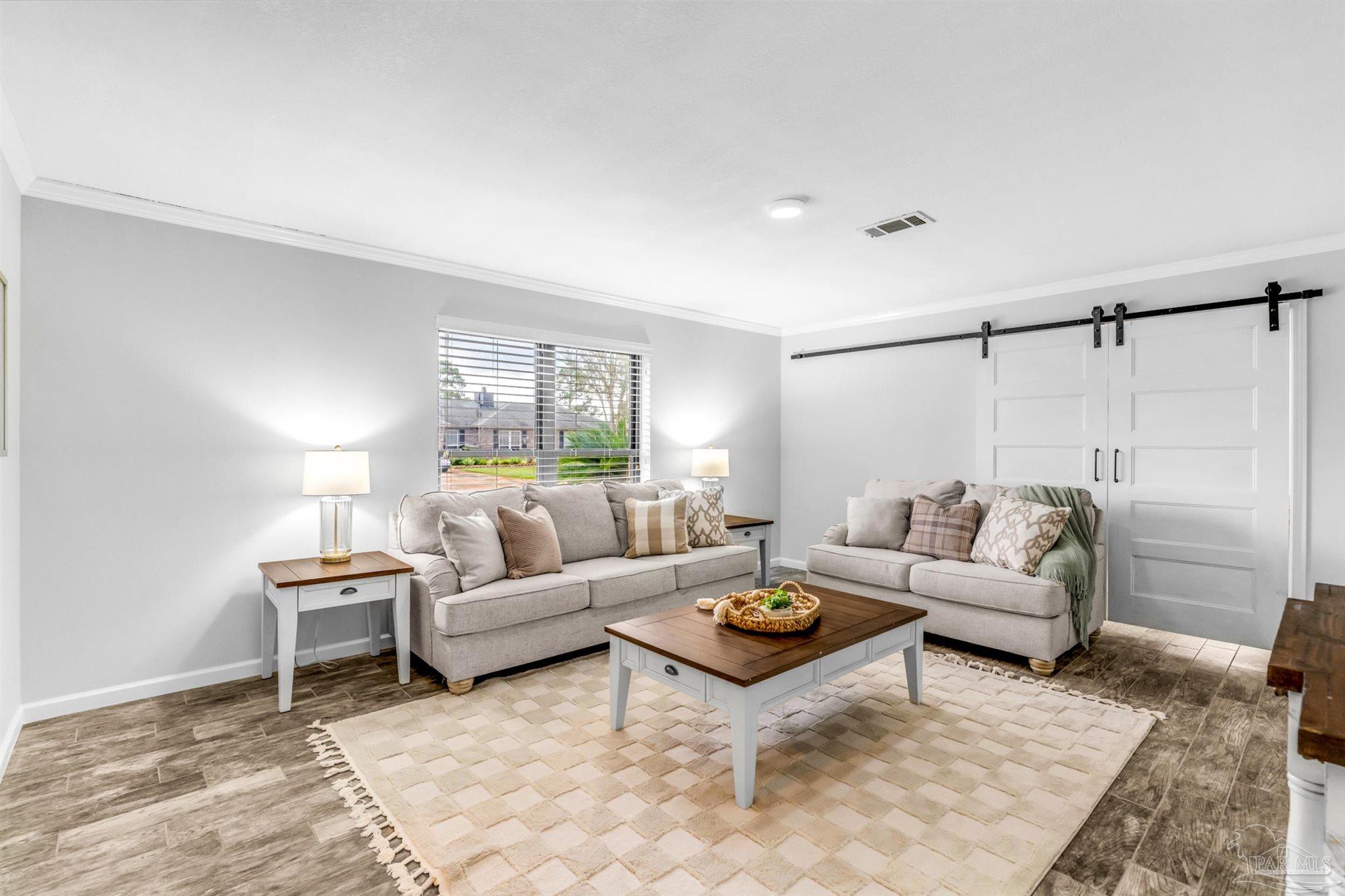 6912 Kitty Hawk Drive Pensacola, FL 32506 - Photo 15 of 61 a living room with furniture and a table