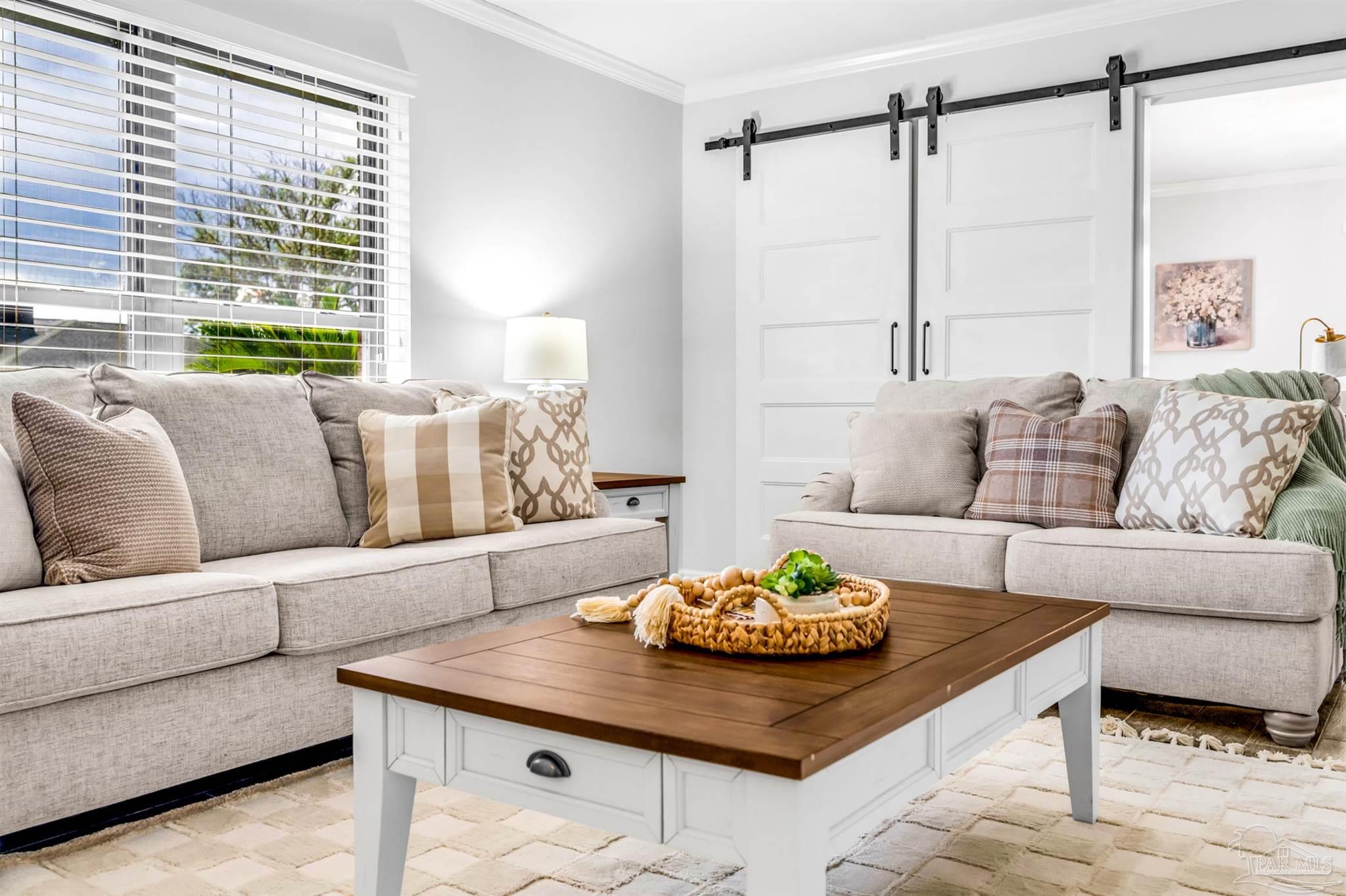 6912 Kitty Hawk Drive Pensacola, FL 32506 - Photo 18 of 61 a living room with furniture and a table
