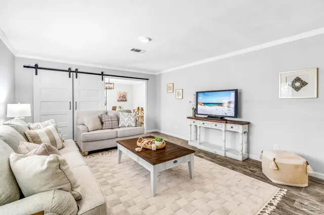 a living room with furniture and a chandelier
