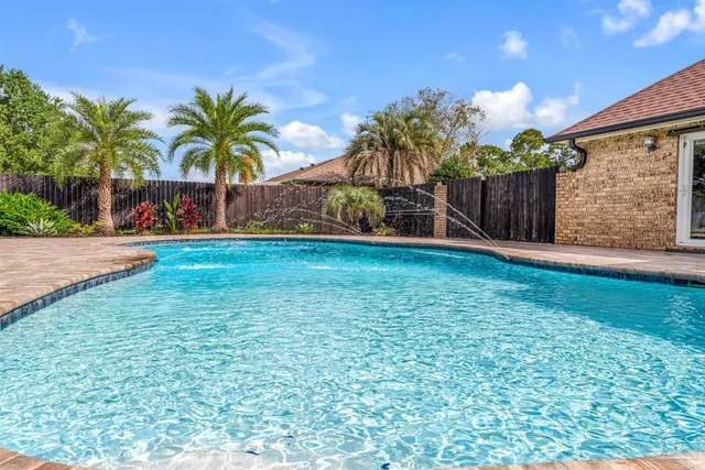 a view of a house with a yard and potted plants