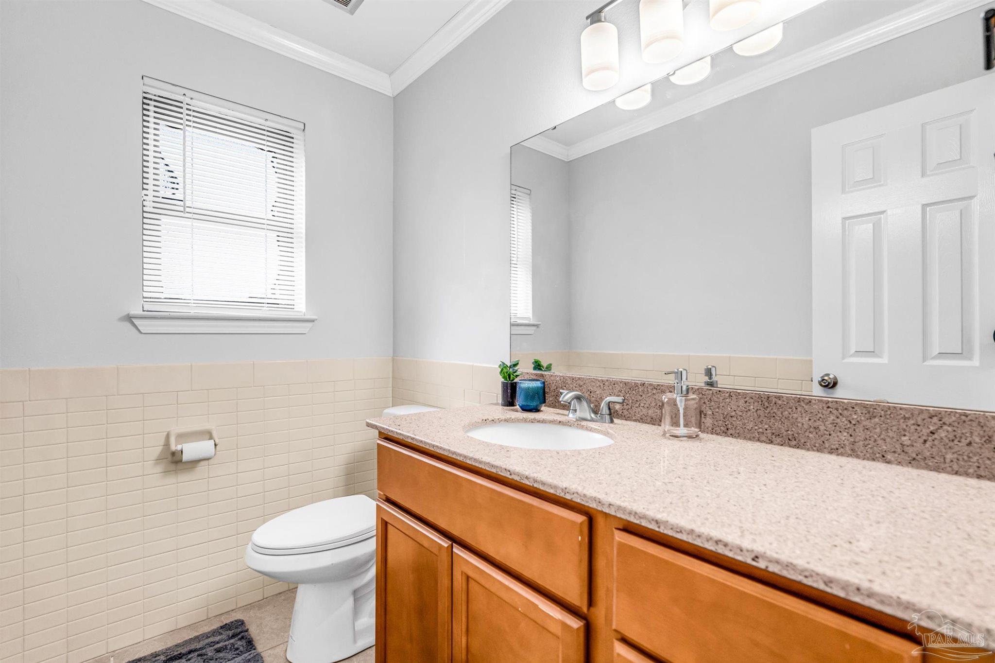 6912 Kitty Hawk Drive Pensacola, FL 32506 - Photo 35 of 61 a bathroom with a double vanity sink toilet and a mirror
