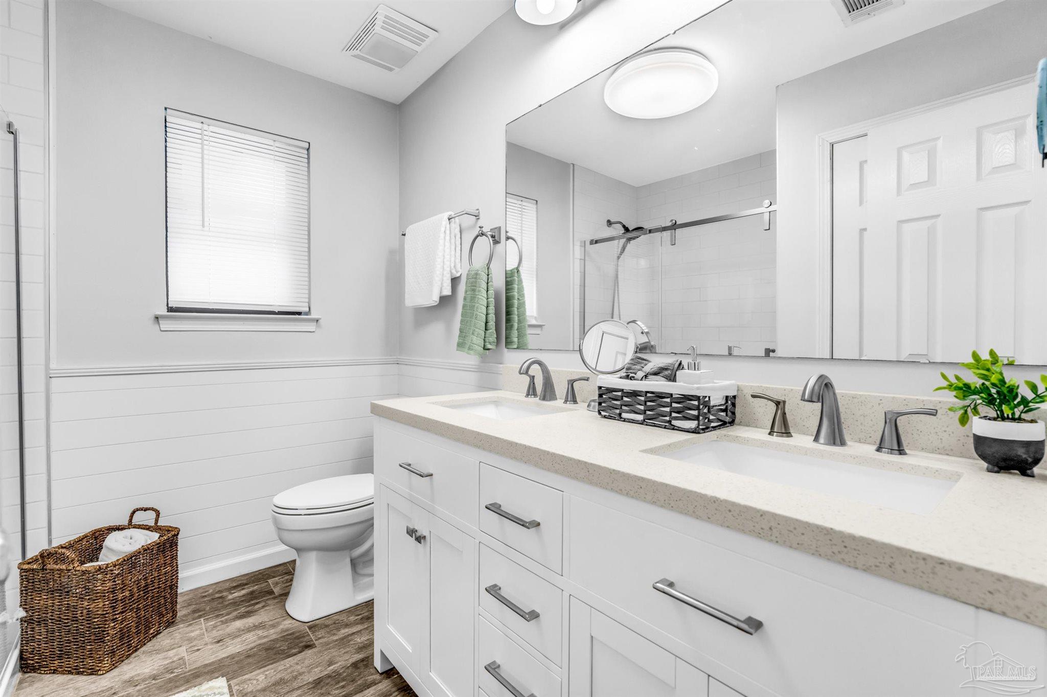 6912 Kitty Hawk Drive Pensacola, FL 32506 - Photo 39 of 61 a bathroom with a granite countertop sink mirror vanity and toilet